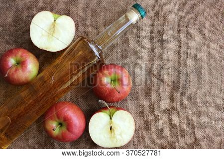 Homemade Apple Cider And Fresh Apples On A Burlap Background, Top View, Copy Space.