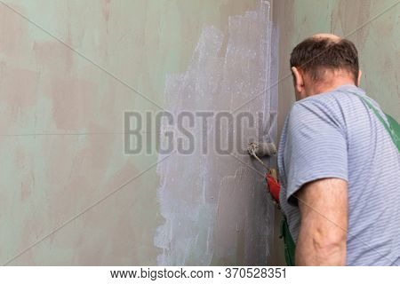 Bathroom Renovation. Construction Worker. Mineral Moisture Insulation. During Work.