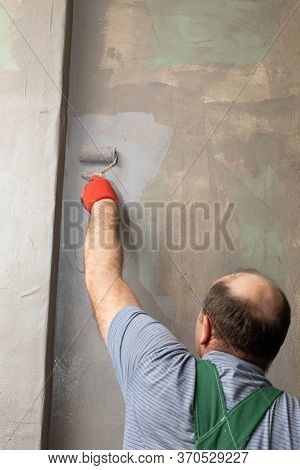 Bathroom Renovation. Construction Worker. Mineral Moisture Insulation. During Work.