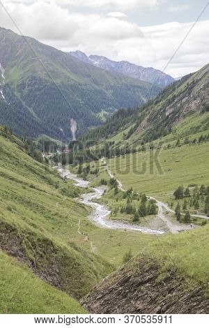 Mountain River, Tourist Route And A Green Valley Between The Mountains In Austrian Alps. View From T