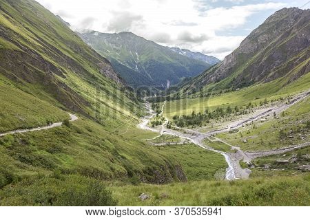 Mountain River, Tourist Route And A Green Valley Between The Mountains In Austrian Alps. View From T
