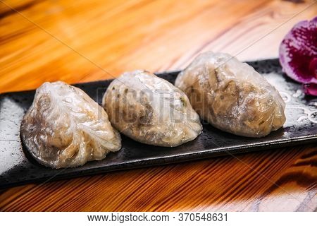 Closeup On Korean Patties Starchy Pyan-se Pygody On The Wooden Table, Horizontal
