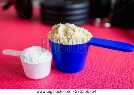 Plastic Spoon Or Measuring Scoop Of Whey Protein And Bcaa On Background Of Sports Equipment, Shaker 