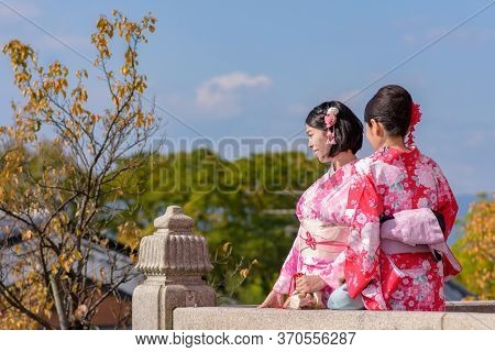 Japanese Girls Dressed In Kimonos At Kiyomizu-dera Temple In Kyoto, Japan