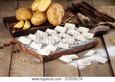 Side View On Semi-finished Potato And Mushroom Dumplings Vareniki On The Wooden Background, Horizont