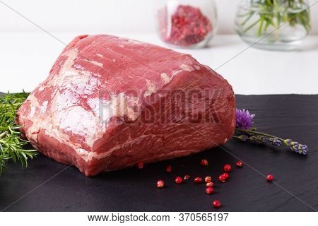 Food Concept Organic Raw Round Beefs Steak On Black Slate Stone Plate With Copy Space