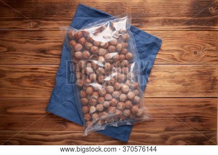 Organic Dried Fruits - Inshell Hazelnuts In Packaging On The Background Of Texture Design And Linen 