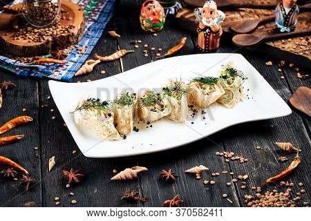 Gourmet Slapjack Rolls With Salmon Filling Black Caviar Dill Garnish On A White Plate, Horizontal