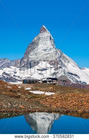Riffelsee Lake And Matterhorn Mountain In The Alps, Located Between Switzerland And Italy