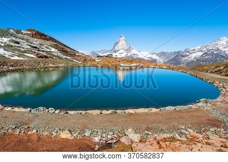 Riffelsee Lake And Matterhorn Mountain In The Alps, Located Between Switzerland And Italy