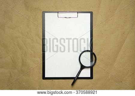 A Tablet With A White Sheet Of A4 Format With Magnifier On A Beige Craft Paper. Concept Of Analysis,