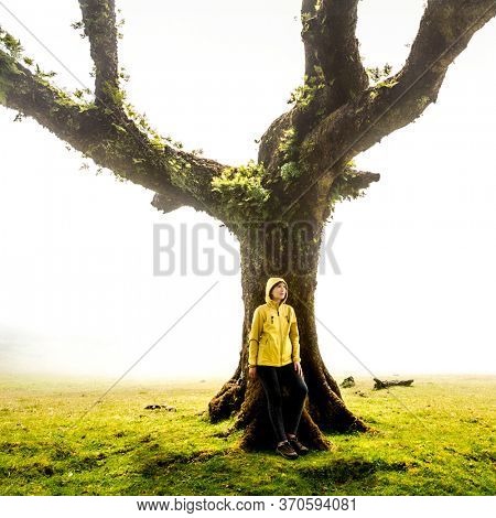 Traveller woman feeling the power of the nature at an ancient forest