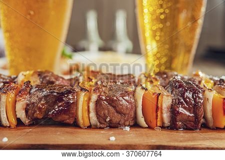 Grilled Meat Stick With Two Glasses Of Beer And Ingredients - Brazilian Espetinho De Carne