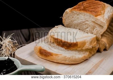Close Up Fresh Homemade Loafs Bread And Sliced Bread On Cutting Board With Jam Strawberry On Wooden 