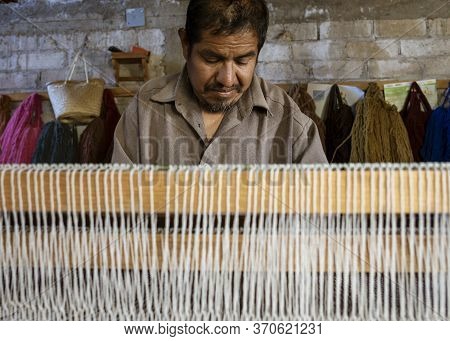 Oaxaca, Mexico - 2019-11-30 - Man Works At His Loom Making A New Blanket.