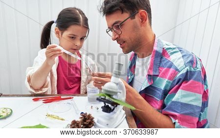 Image Of A Little Girl Doing Science Experiments In The Laboratory With Father. Dad And Daughter Stu