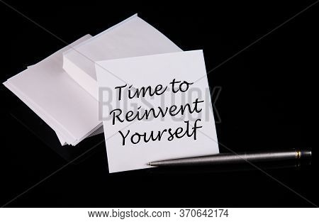 Conceptual Hand Writing Time To Reinvent Yourself Message On A White Sticker With Pen On A Black Tab