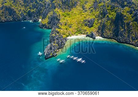 Aerial View Of White Boats In Open Sea Close To Tropical Miniloc Island. El Nido, Palawan Island, Ph