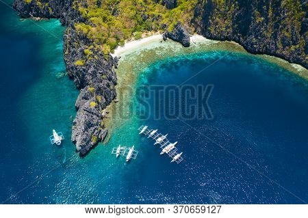 Aerial View Of White Diving Boats On Spot Close To Tropical Miniloc Island. El Nido, Palawan Island,