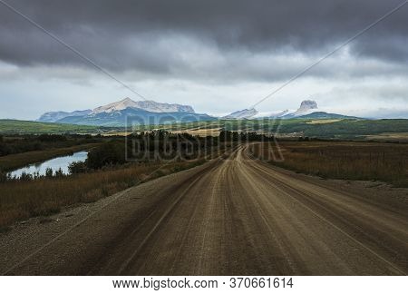 Dirt Road Leads To The Glacier Mountains Cloudy Morning Dark Blue Tone Thick Clouds