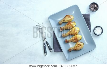 Grilled Chicken Legs On Plate On Grey Background. Top View.