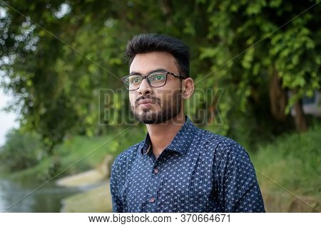 Portrait Of A Young And Handsome Indian Bengali Man Standing In Front Of Prinsep Ghat Wearing A Blue
