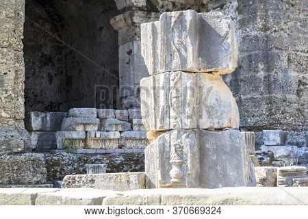 View Of The Ruins Of An Ancient Column With The Image On The Bas-relief Of A Wine Jug And A Vine