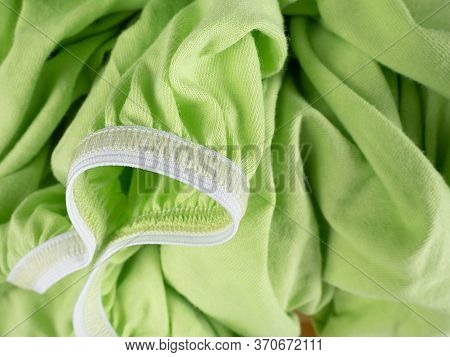Closeup Elastic Band On The Green Sheet