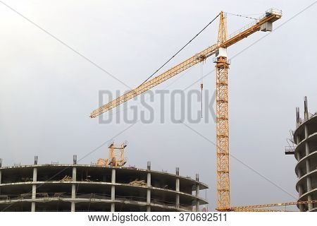 Urban Building Under Contsruction With A Crane