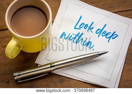 look deep within inspirational and spiritual handwriting on a napkin with a cup of coffee