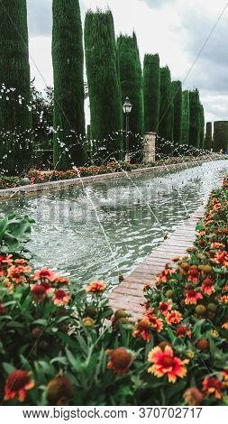 Cordoba / Spain - October 2019: Beautiful Pool With Fountains In A Garden Of Famous Fortress Alcázar