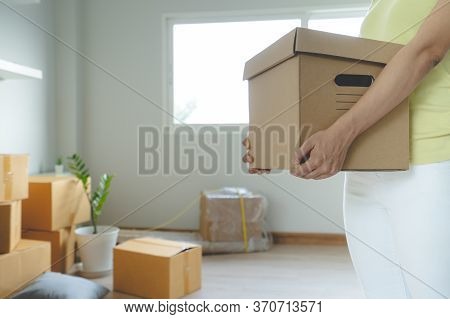 Relocation To New House. Woman Carrying Stuff Box And Moving In New Apartment.