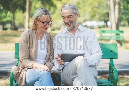 Technology Connect And Modern Elderly Lifestyles Concept. Aged Senior Couple Waving Hands Greeting G