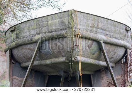 Old Metal Boat In Dry Dock For Repair. Close Up Of The Bow Of An Old Tin Or Galvanised Metal Boat.