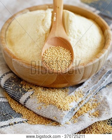 Bowl Of Raw Amaranth Flour With A Spoon Of Amaranth Seeds Close Up