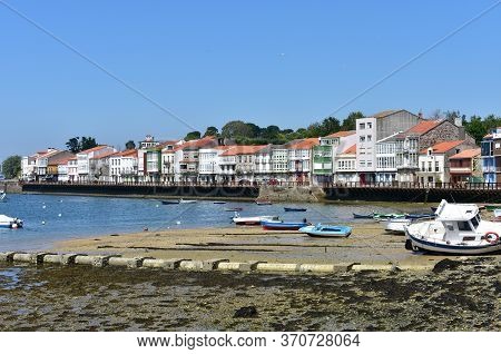 Mugardos, Spain. May 30, 2020. Fishing Village With Wooden Boardwalk, Colorful Houses And Boats With