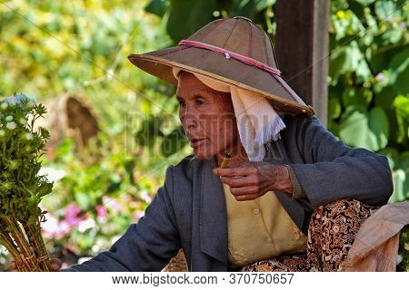 Heho, Myanmar - Nov 08, 2019: Smoking Woman At A Market In The City Center Of Heho In Myanmar, Forme