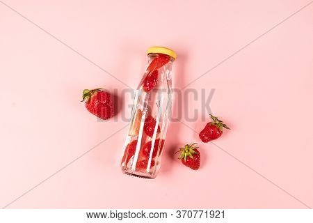Bottle Of Detox Water, Cocktail, Lemonade Or Tea With Fresh Strawberry Summer Fruit On Pnk Backgroun