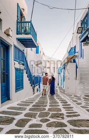 Mykonos Greece, Couple Man And Woman On Vacation At The Greek Island Mykonos, Girl In Dress At The W