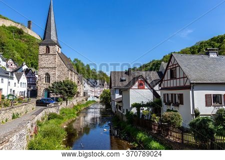 River Elz With Half-timbered Houses And Church In Monreal, Germany
