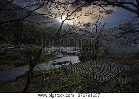 A Landscape Of A River And Mountains In Athirapally Named Waterfall Area Located In Kerala State, So