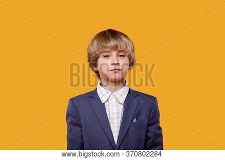 A Beautiful Blonde Child With Bright Eyes Looks Into The Camera.