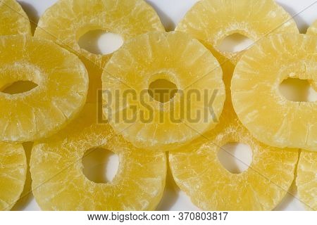 Yellow Pineapple Candies, Sliced In Round Slices In Powdered Sugar, On A White Background.