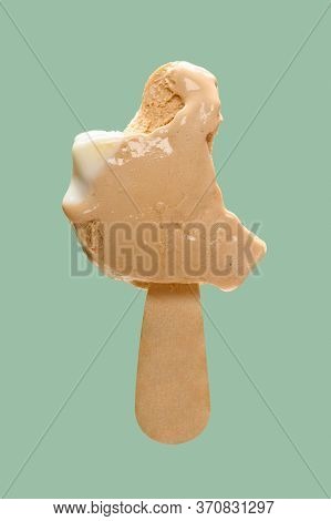 Cheese And Lemon Flavor Popsicle With The Last Bit On Green Background