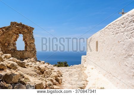 White Chapel And Old Ruins On The Hill Of Monolithos Castle On Rhodes Island. Greece