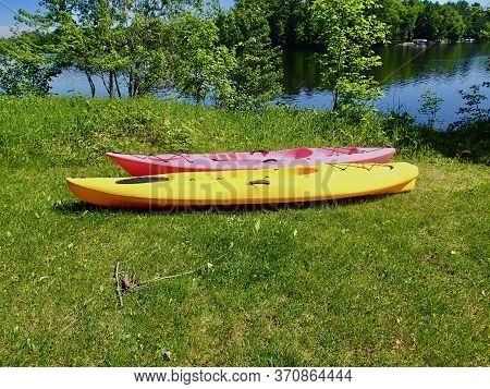 Two Kyaks On The Shore Of A Freshwater Lake