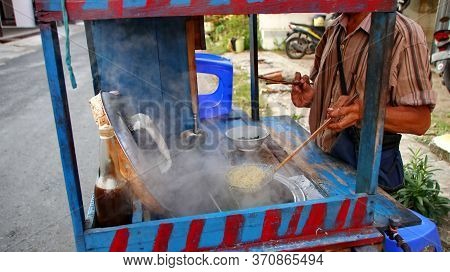 Indonesian Food, Mie Ayam, Noodles With Chicken Presented Directly By The Seller On The Cart, Unfocu