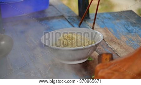 Indonesian Food, Mie Ayam, Noodles With Chicken Presented Directly By The Seller On The Cart, Unfocu