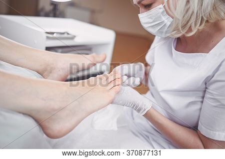 Pedicurist Doing Professional Medical Pedicure Procedure In Beauty Salon With Special Eguipment. Foo