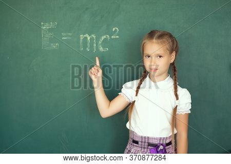 Portrait Of Caucasian Happy Child Girl. School Chalkboard Or Blackboard Background. Education And Sc